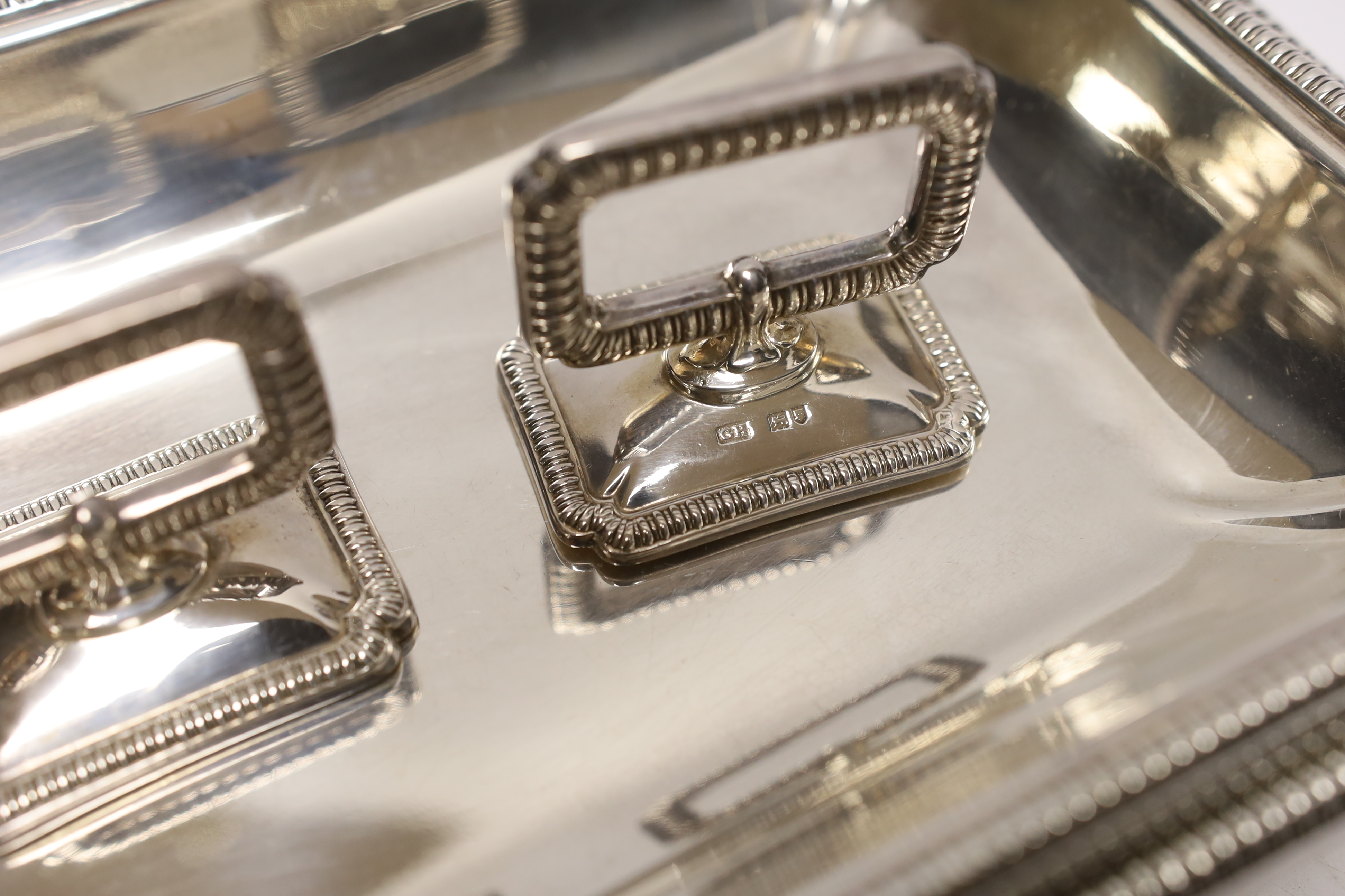 A pair of George V silver rectangular entrée dishes with covers and handles, by George Howson